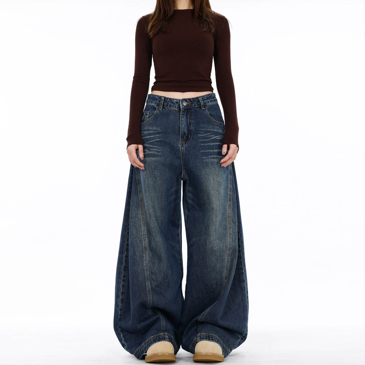 En model bærer mørke jeans med ekstra vide ben og synlige sømdetaljer mod en lys baggrund._0