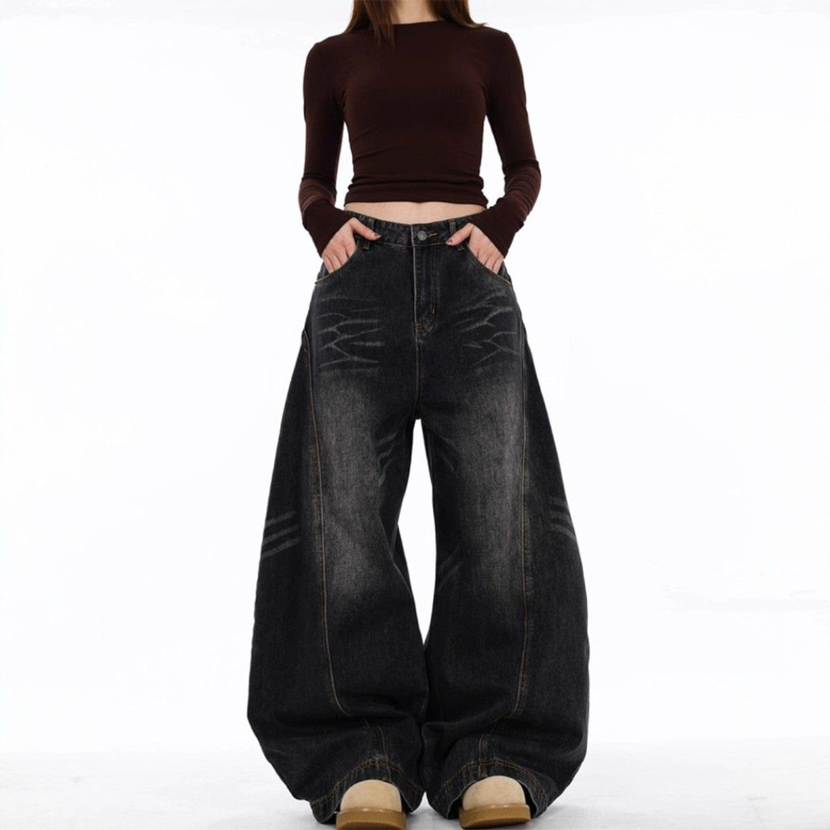 En model bærer mørke jeans med ekstra vide ben og synlige sømdetaljer mod en lys baggrund._3