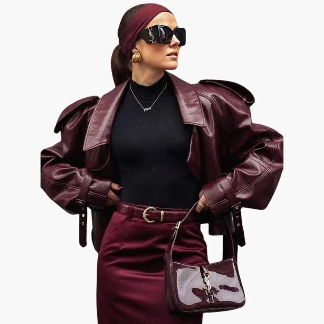 Kortet bikerjakke i dyb burgundy-brun nuance med notch lapel, asymmetrisk knaplukning og bælte i taljen, vist fra fronten_1