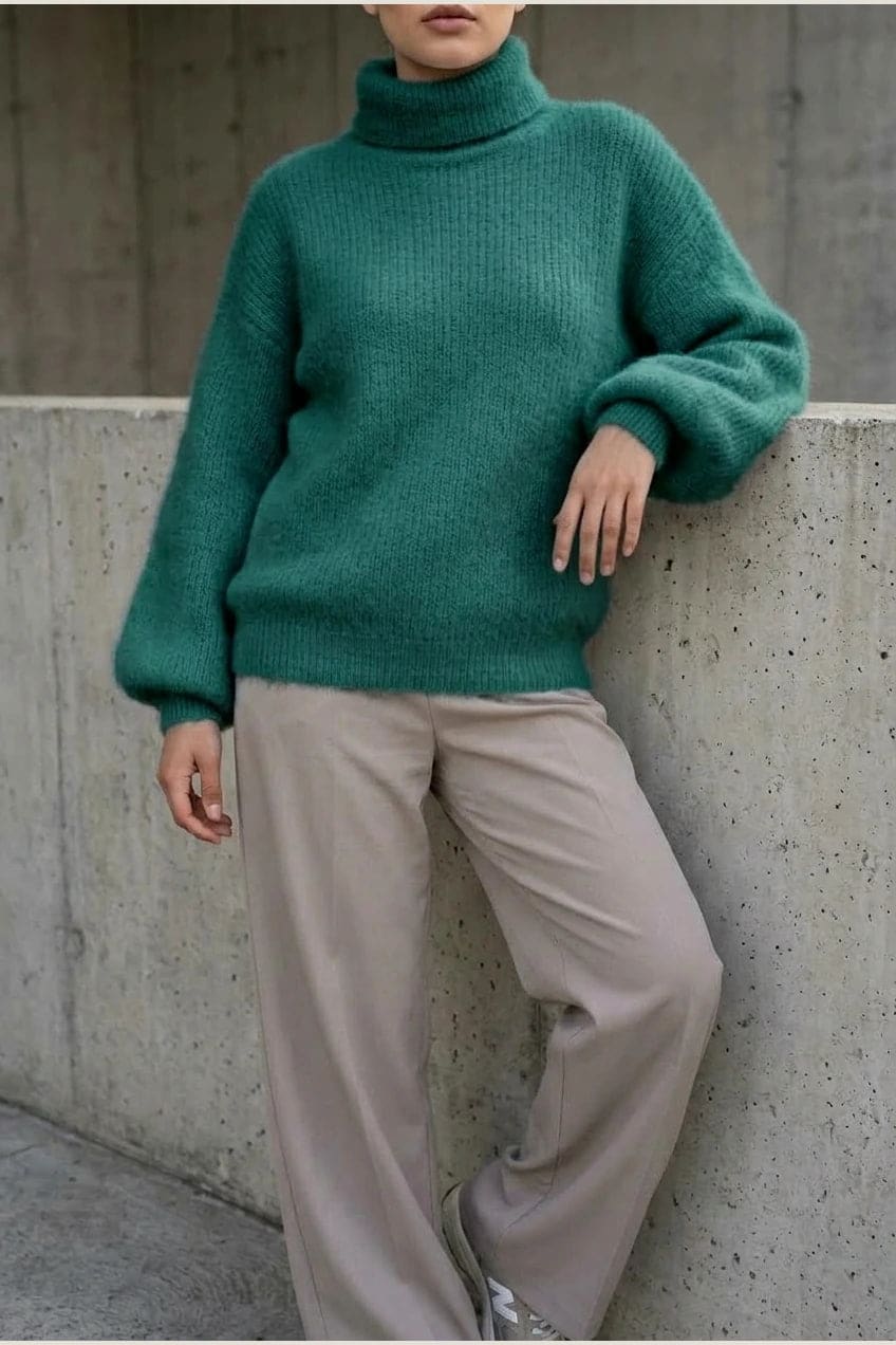 Model i lys, luftig rullekravesweater med ballonærmer, ribbede manchetter og kant, stylet med grå bukser og hvide sneakers._14
