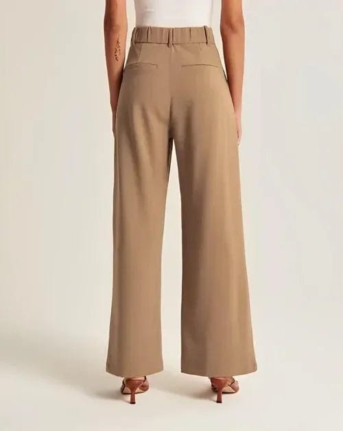 Kvinde iført lyse wide-leg bukser i høj talje, skræddersyet pasform, med cropped top og blazer._16