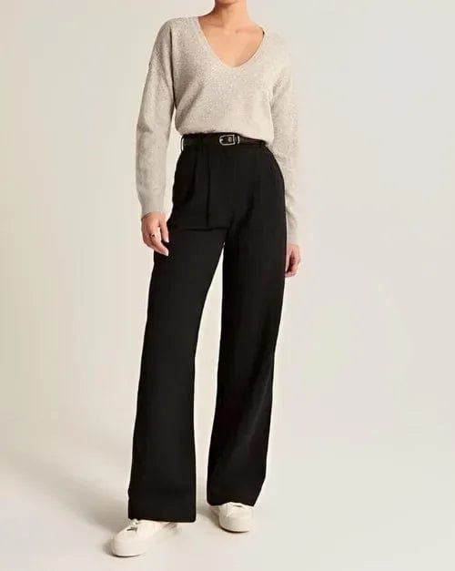 Kvinde iført lyse wide-leg bukser i høj talje, skræddersyet pasform, med cropped top og blazer._20