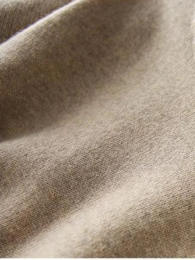 Model iført beige strikket sæt bestående af løstsiddende sweater og matchende nederdel med sliddetalje_20