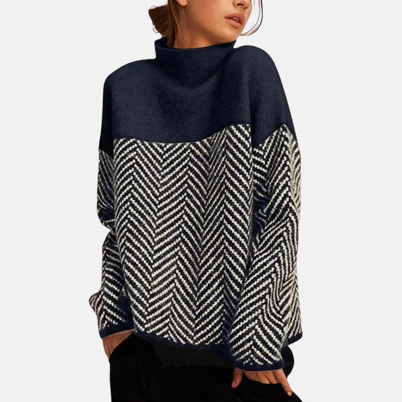 Kvinde iført en strikket sweater med høj krave og grafisk fiskebenmønster i todelt design._0