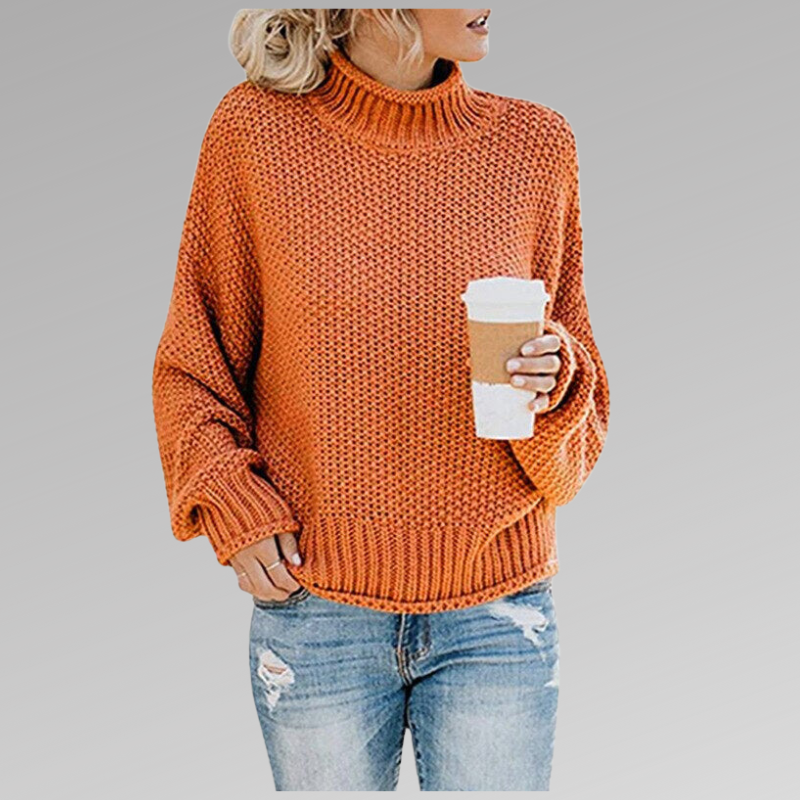 Kvinde iført en orange strikket sweater med høj hals og afslappet pasform, der holder en kop kaffe_0