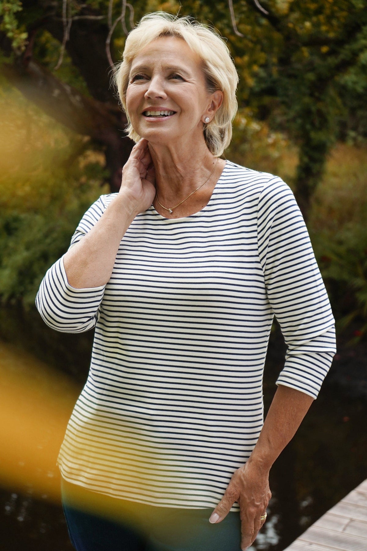 Kvinde i stribet bluse med rund hals og 3/4 ærmer til jeans._2