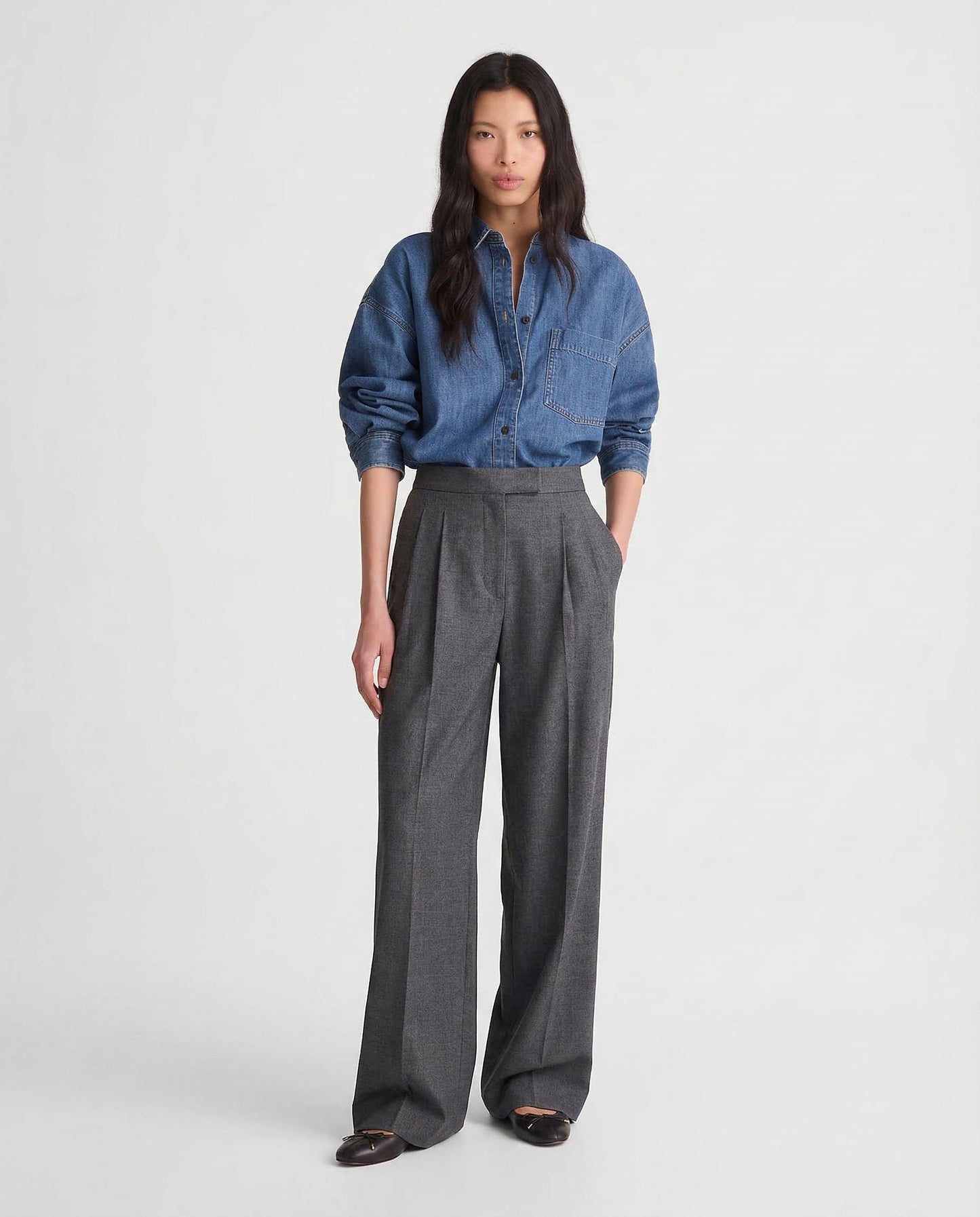 Model iført wide leg bukser med høj talje og plissering, stylet med denim skjorte._4
